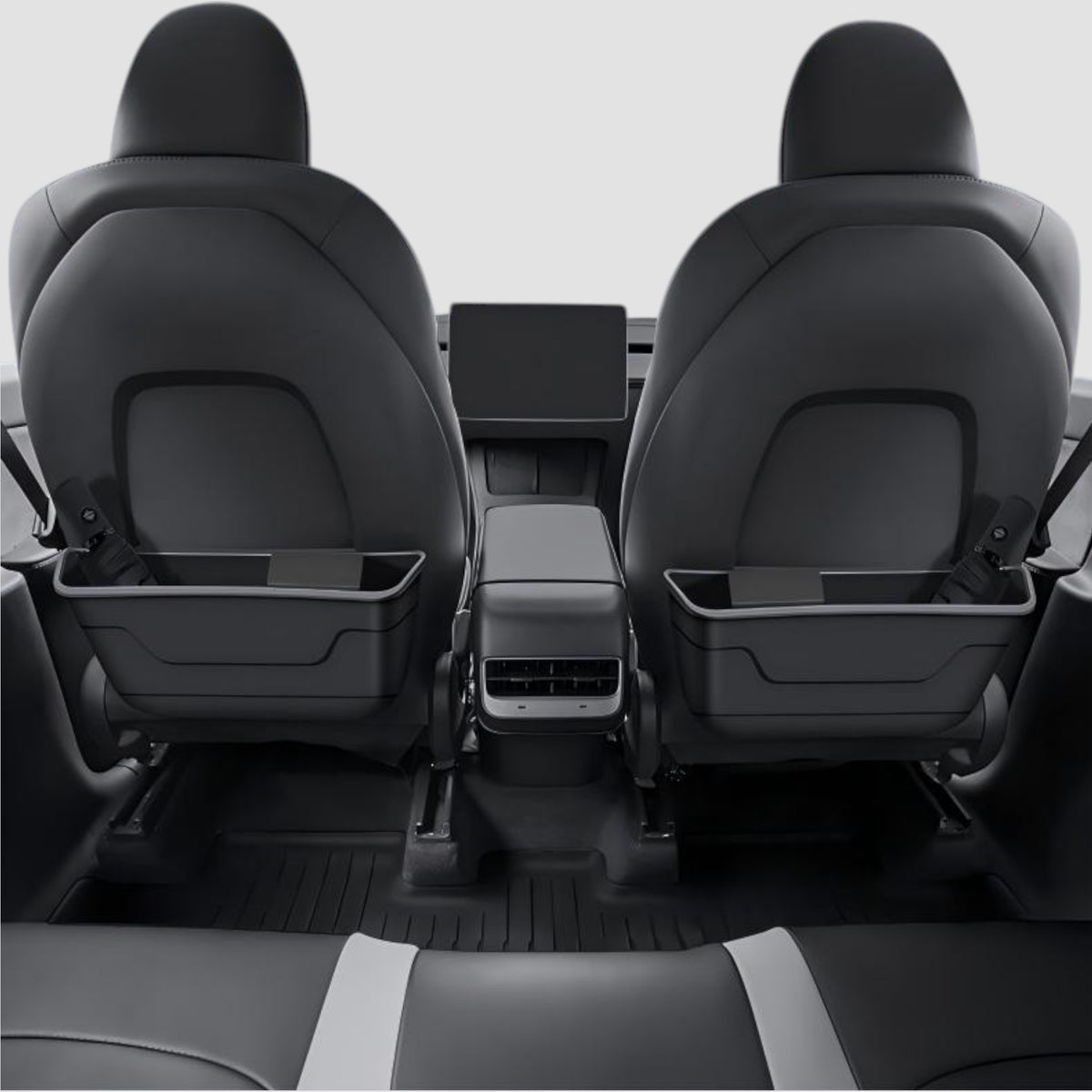 To affaldsbeholdere monteret på bagsiden af begge forsæder i Tesla, set fra bagsædet