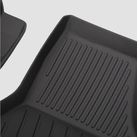 Detaljer af sort 3D All Weather måttesæt med riller til bilens bagagerum.