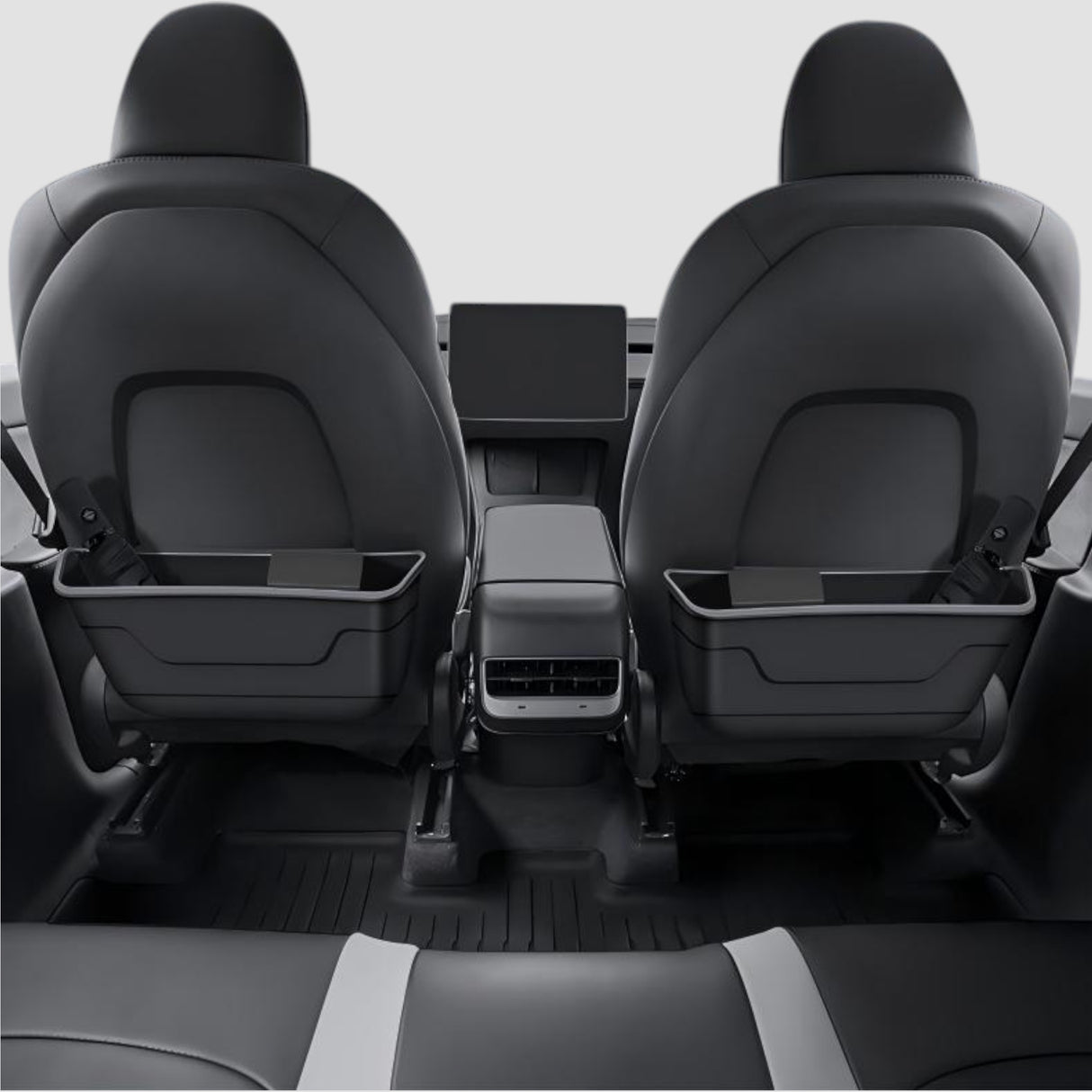 To affaldsbeholdere monteret på bagsiden af begge forsæder i Tesla, set fra bagsædet