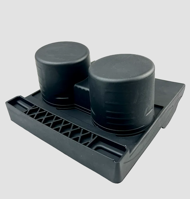 Sort kopholder set fra undersiden med koprør og ventilationsriller på lys baggrund